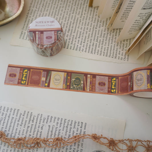 Close-up of hand-inked antique book spines on gold foiled washi tape, featuring titles such as pride and prejudice, little woman and anne of green gables. Designed in the UK and hand drawn by Rebecca.
