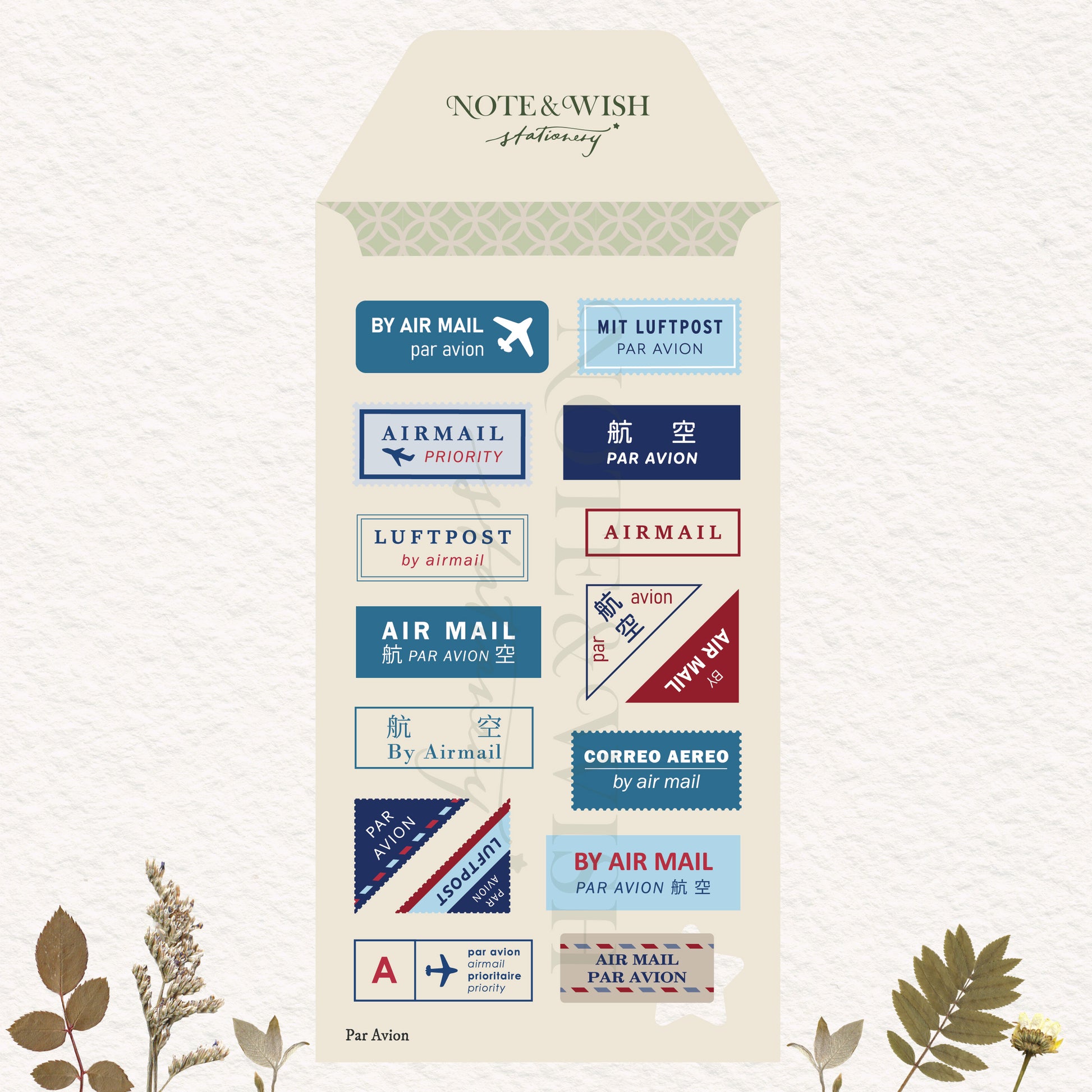 A decorative cream-colored envelope-shaped card or packaging insert featuring multiple postage-style air mail labels in blue, red, beige, and navy. 