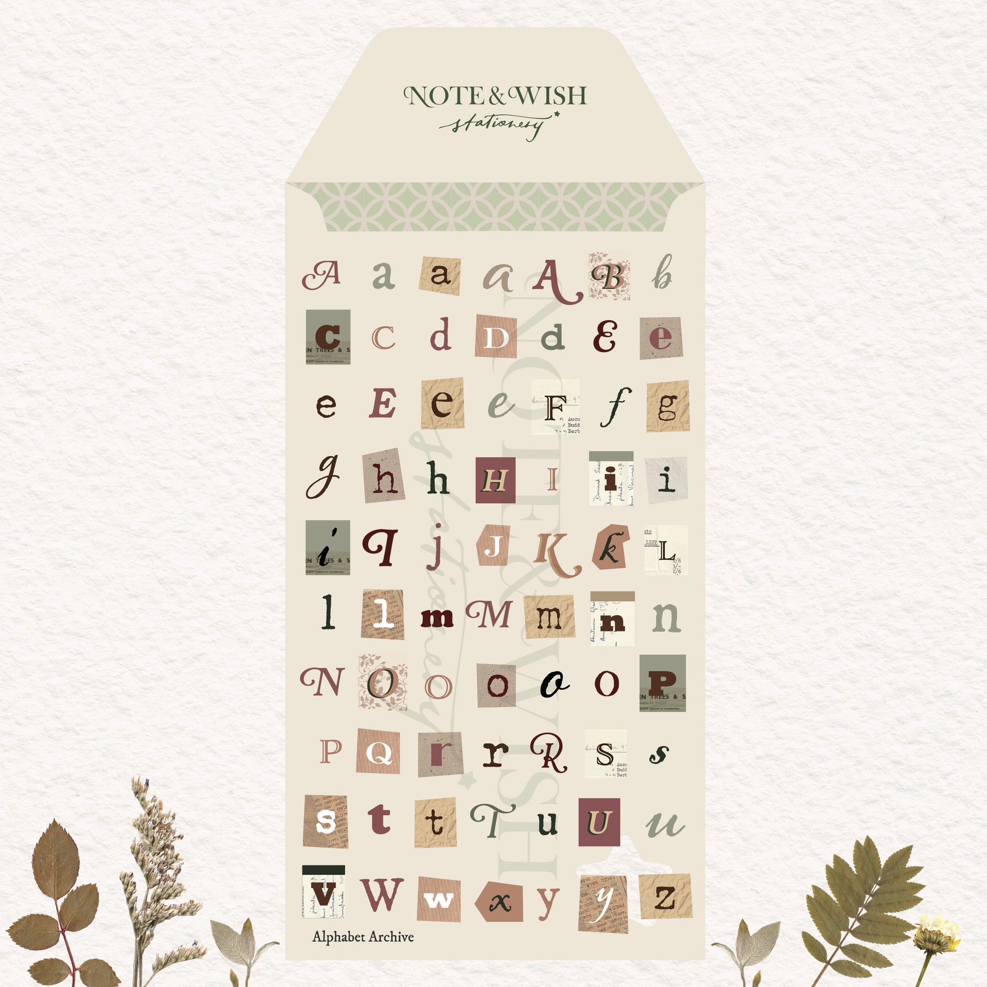 A decorative lettering sheet from Note & Wish called Alphabet Archive, featuring vintage-style mixed-case alphabet stickers in muted earthy tones on a cream envelope-shaped backing, with botanical illustrations at the bottom.