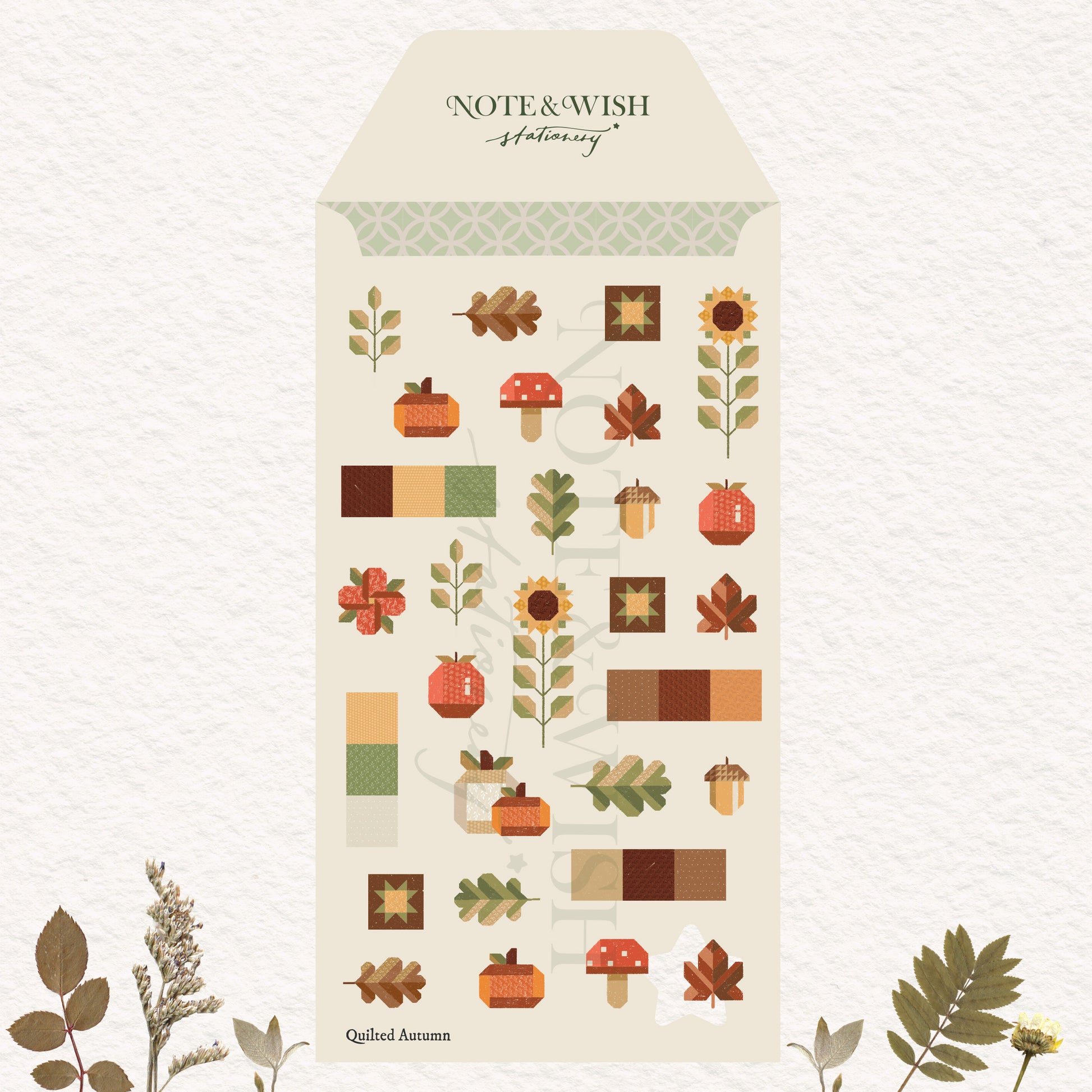 autumn-themed stickers displayed on a textured off-white background with decorative botanical elements at the bottom corners. The sheet features illustrations of pumpkins, acorns, mushrooms, leaves, sunflowers, and color blocks in warm autumn tones.