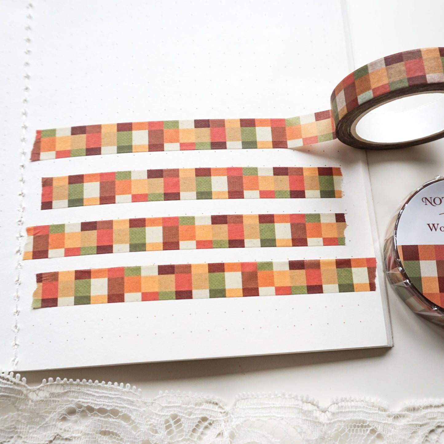autumn check washi tape features a cosy woven check pattern in deep reds, browns, oranges, and greens.