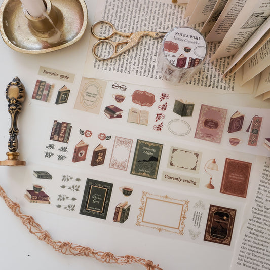Sheet of decorative PET tape dark academia style stickers with book-themed designs on a surface with a candle and scissors. Books include Little Women, Pride and Prejudice, Wuthering Heights and Frankenstein.