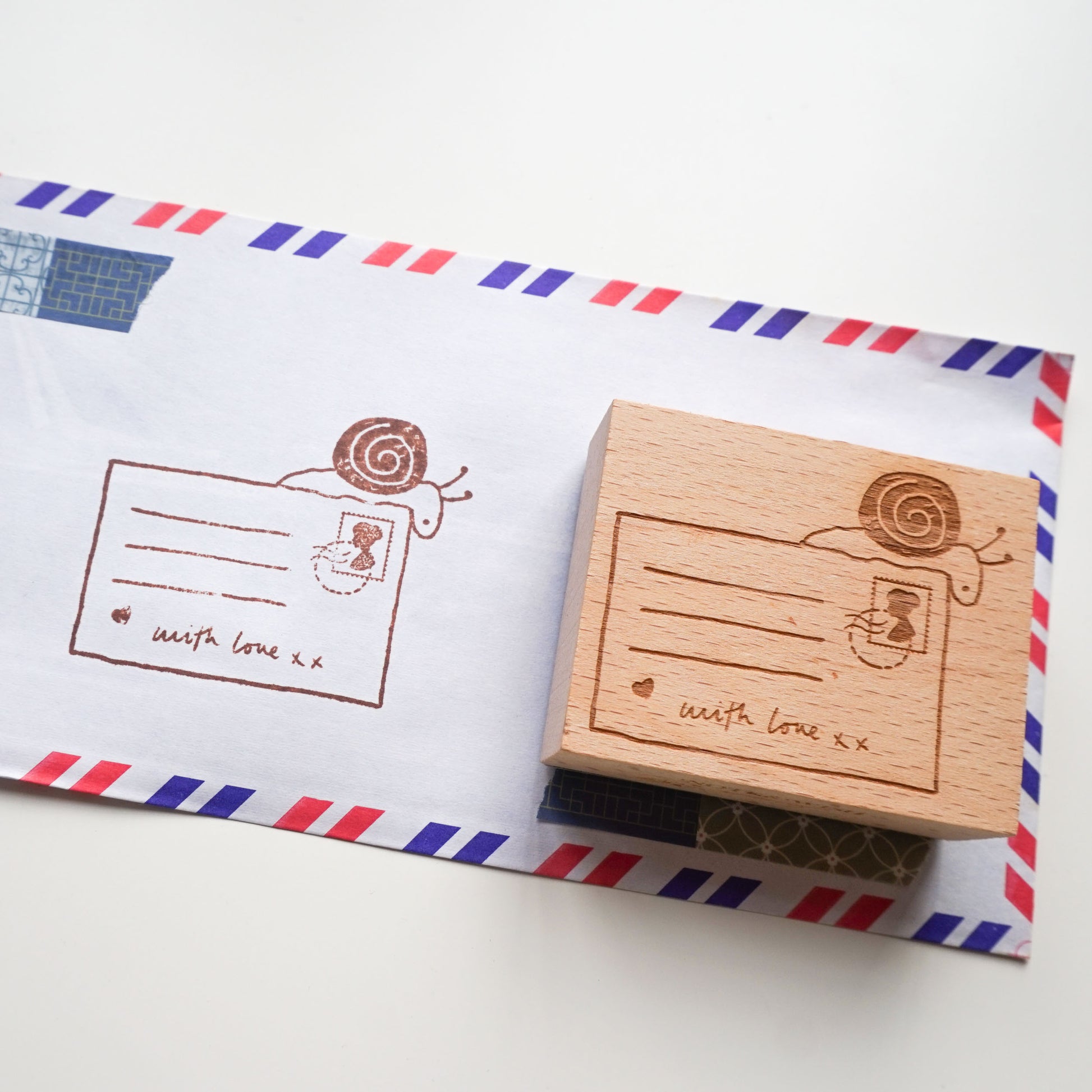 Snail mail rubber stamp featuring a hand-drawn illustration of a snail and postcard
