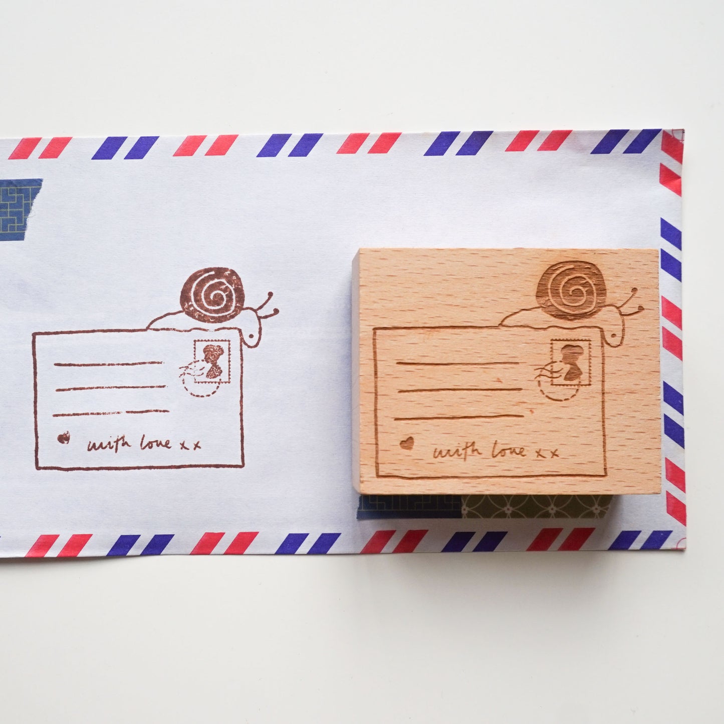 Snail mail rubber stamp featuring a hand-drawn illustration of a snail and postcard