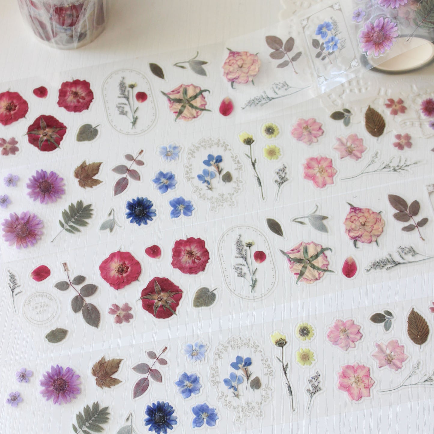 Pre-cut pressed flower PET tape featuring camellias, delphiniums &amp; plum blossoms.