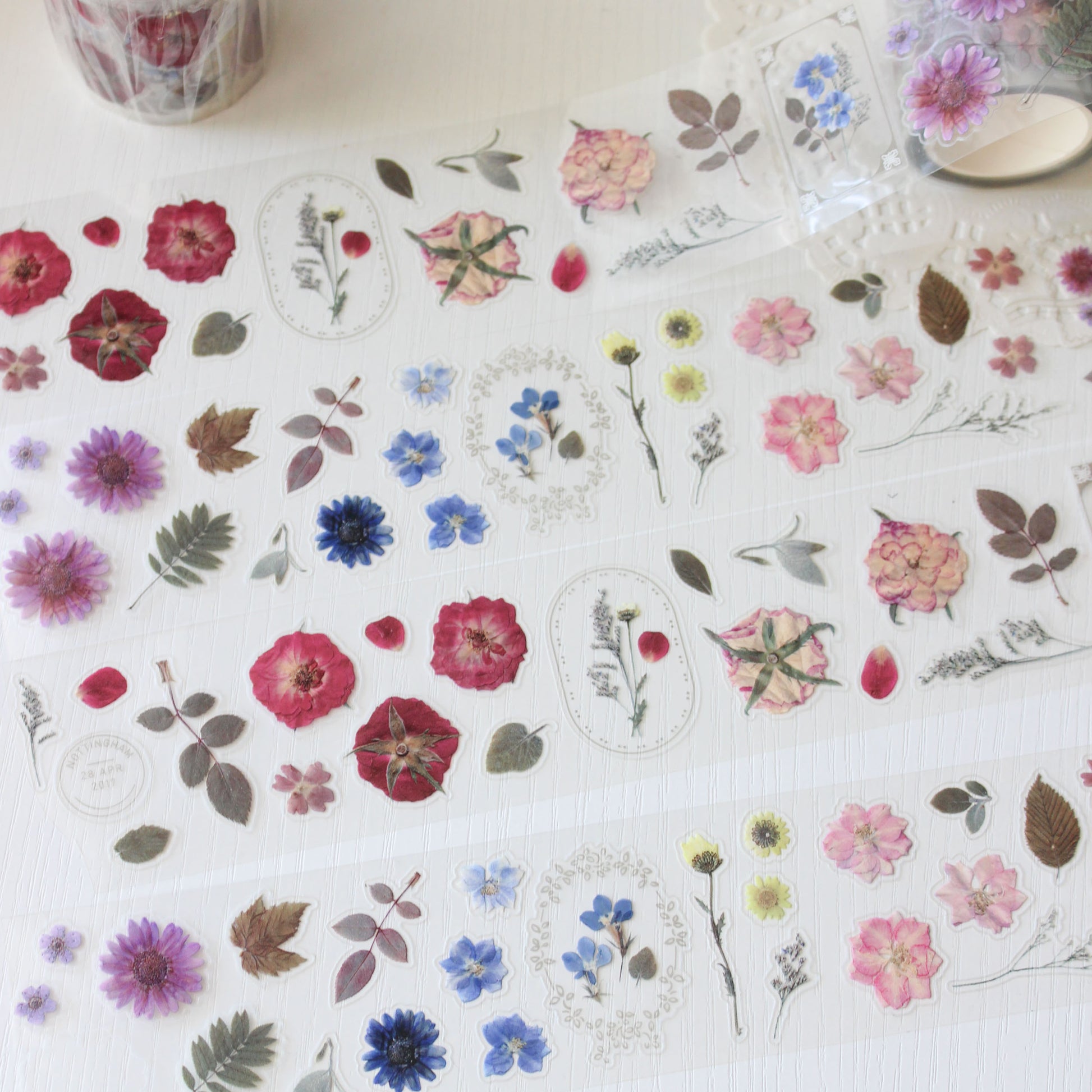 Pre-cut pressed flower PET tape featuring camellias, delphiniums &amp; plum blossoms.