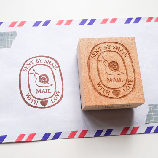 Hand-drawn snail mail rubber stamp featuring a cute snail illustration. 