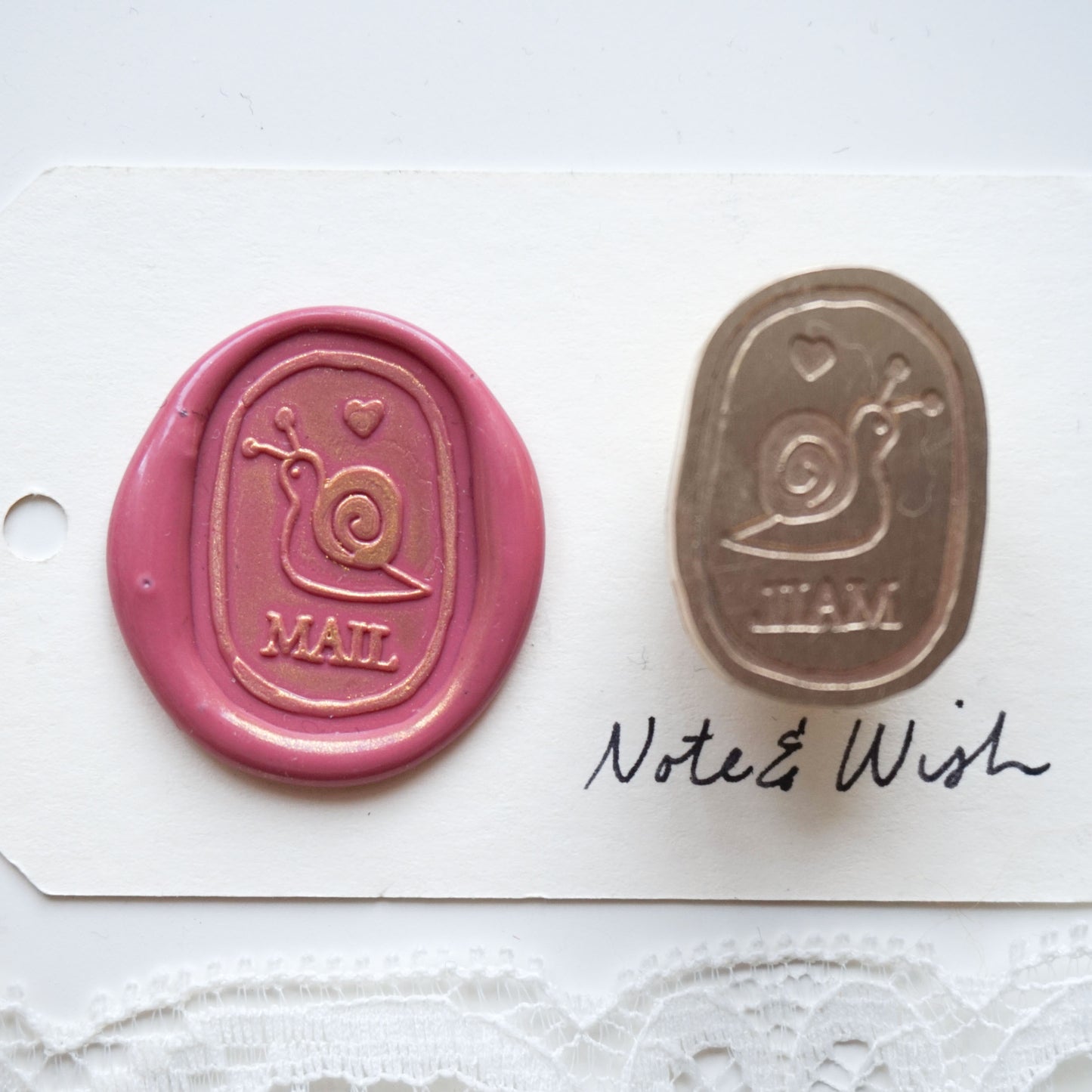 wax seal stamp with a snail on it and the word mail