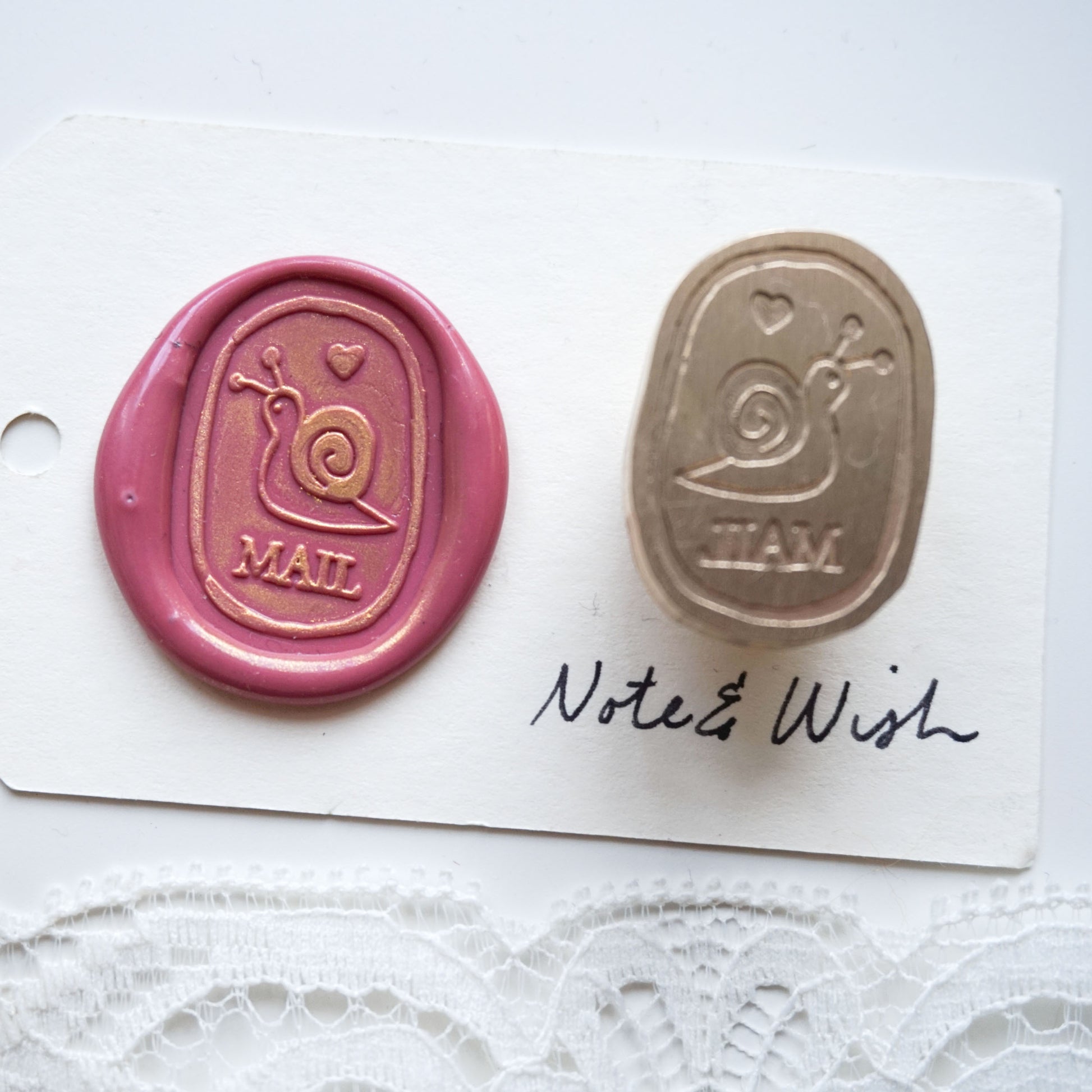 wax seal stamp with a snail on it and the word mail