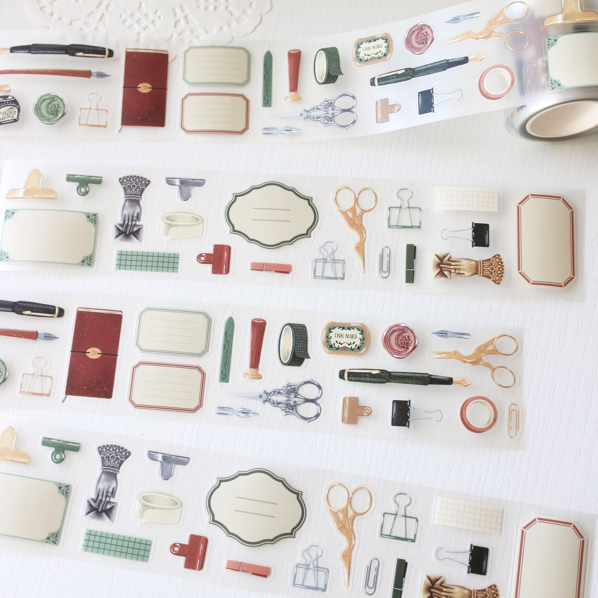 Stationery essential pre cut PET tape featuring hand-painted illustrations of vintage stationery such as wax seal stamps, fountain pens and ornate scissors. 